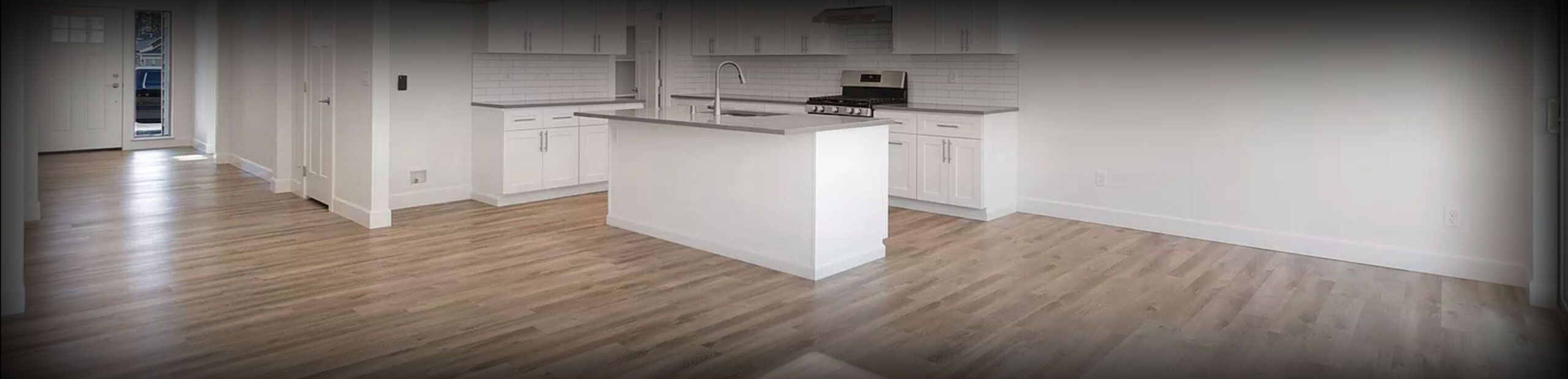 image of a kitchen with a nice hardwood floor fro Cost Less Carpet